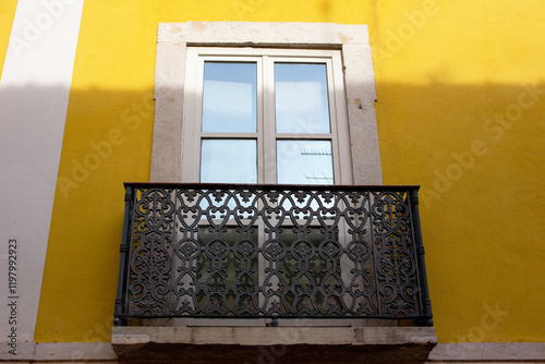 Balcony on a yellow wall in the city of Lisbon, Portugal