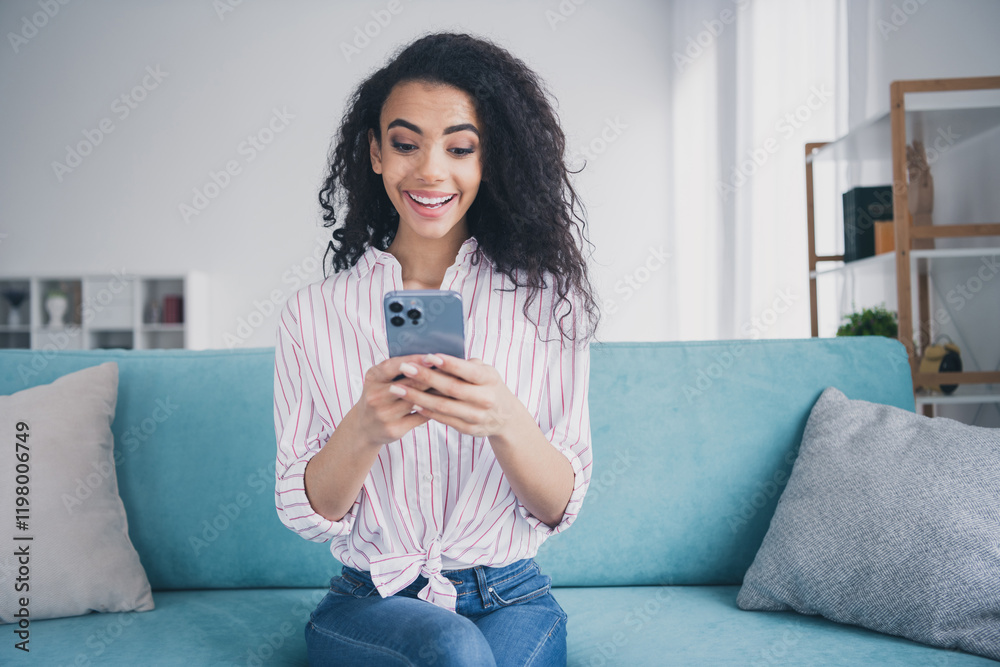 Photo of pretty young girl use phone chatting wear striped shirt weekend free time apartment indoors Photo of pretty young girl use phone chatting wear striped shirt weekend free time apartment indoors