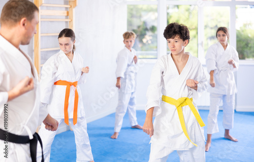 Preteen children during karate training. Martial arts. Active lifestyle concept photo