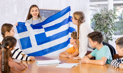 Teacher with flag of Greece tells story of the emergence of the state photo