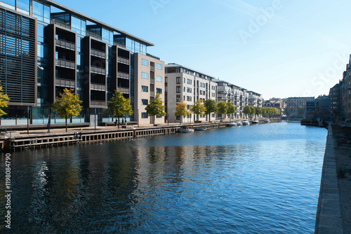 Modern residential buildings of Copenhagen in front of the canal with boats. Denmark