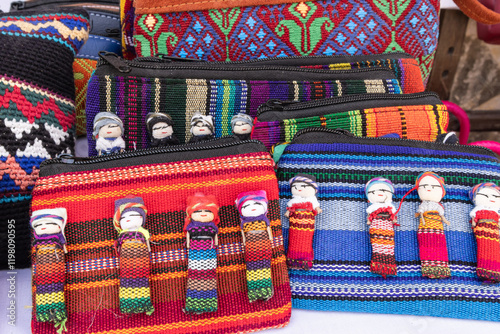Hand bags made from colorful traditional woven cloth and decorated with worry dolls at a market near Lake Atitlan.