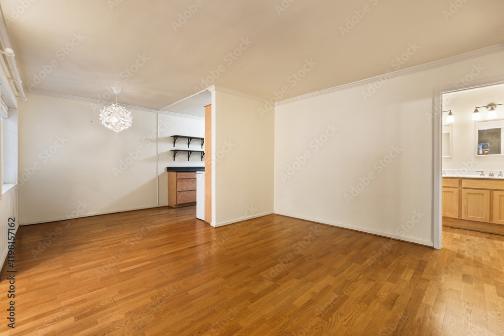 Spacious living room with wooden flooring and sliding doors leading to a bright outdoor area Spacious living room with wooden flooring and sliding doors leading to a bright outdoor area