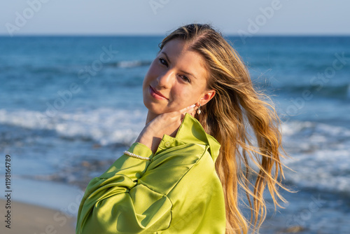 Young white woman in black bikini on the beach at sunset