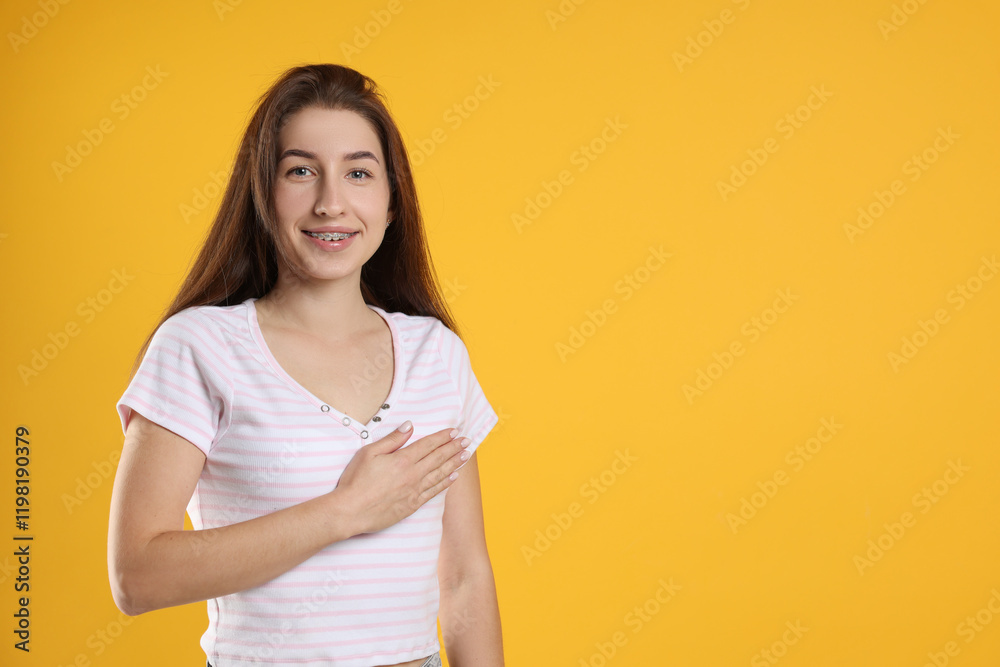 Woman making promise on orange background, space for text. Oath gesture Woman making promise on orange background, space for text. Oath gesture