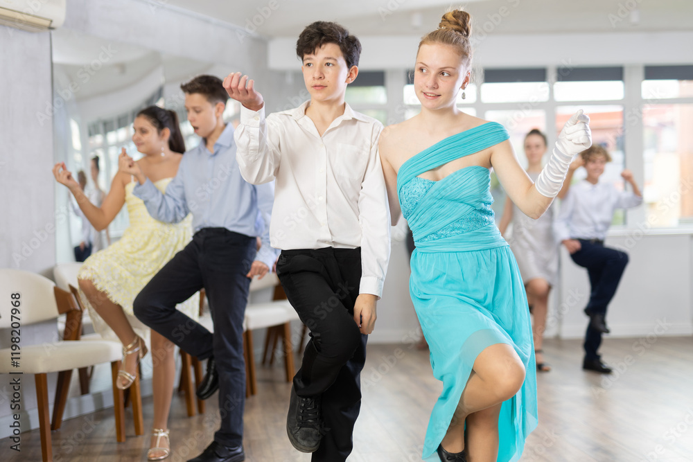 Fototapeta premium Boy and girl dance energetic twist dance in studio