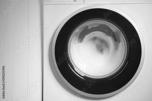 Washing machine with suds as background, closeup