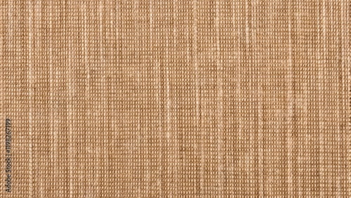 Jacquard woven coarse weave texture upholstery orange fabric. Textile background, furniture textile material, wallpaper, backdrop. Cloth structure close up, macro.
 photo