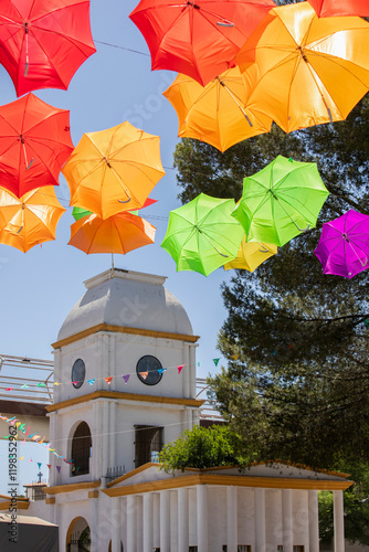 Colorful papel picado frames the historic clock tower of the downtown train station in Heroica Nogales, Sonora, Mexico. photo