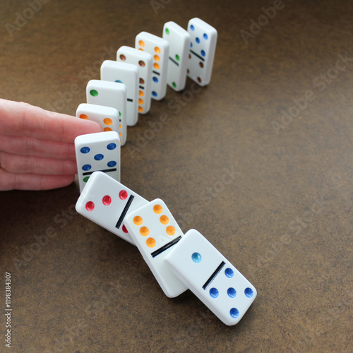 abstract person stopping dominoes from falling isolated on background metaphor for cause and effect, fate, causality, fallen, chain reaction, insurance, predictability business backdrop