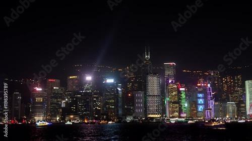 Wallpaper Mural Hong Kong skyline shining at night with light beams from buildings and boats passing by in victoria harbour Torontodigital.ca