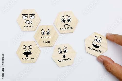 Fototapeta wooden puzzle with icons of 6 facial expressions and the words anger, happiness,