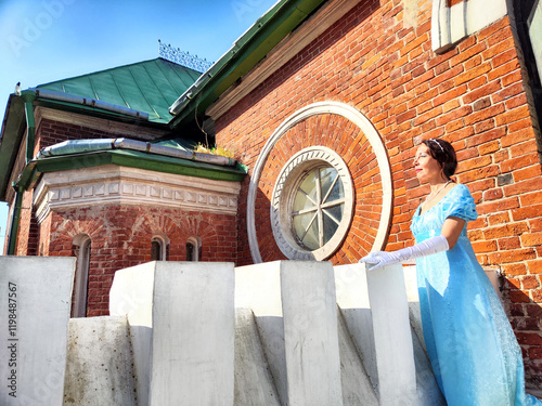 A romantic princess gazes thoughtfully from a vintage castle's terrace, immersed in a timeless daydream under a clear sky photo