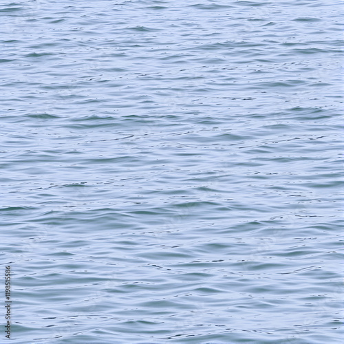 A lake's surface is dotted with ripples as wind stirs the calm water, natural elements, rippled lake surface photo