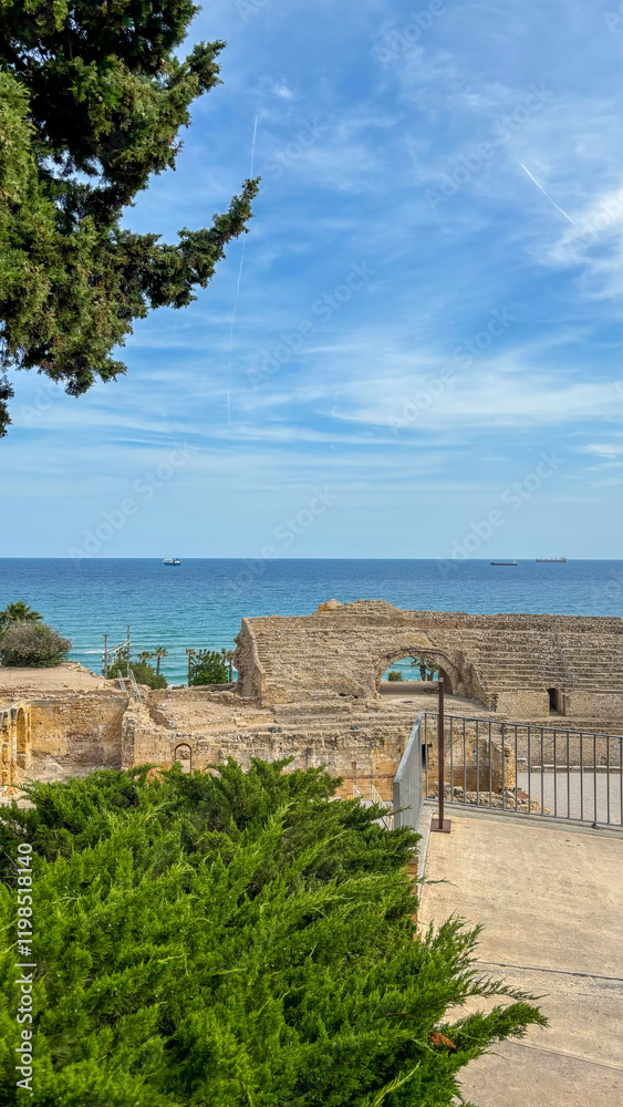 A beautiful view of ancient ruins facing the sea, framed by lush greenery and a serene sky. A peaceful combination of history, nature, and the Mediterranean coastline. A beautiful view of ancient ruins facing the sea, framed by lush greenery and a serene sky. A peaceful combination of history, nature, and the Mediterranean coastline.