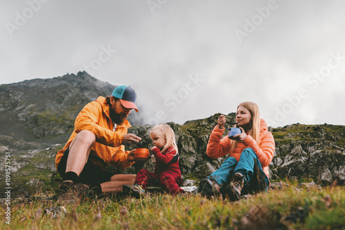Family on picnic in mountains camping travel - father, mother and child eating hiking food, parents and kid having lunch outdoor together active adventure vacations backcountry kitchen