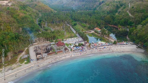 Aerial view of a sandy beach and warungs at sunset (Crystal Bay, Nusa Penida) photo