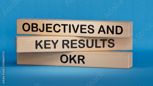 Wallpaper Mural OKR word written on wood block. OKR word is made of wooden building blocks, business concept. OKR short for objectives and key results.3D rendering on blue background. Torontodigital.ca