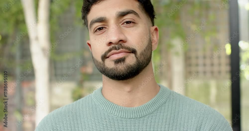 Smiling young man in casual sweater, looking confidently at camera Smiling young man in casual sweater, looking confidently at camera