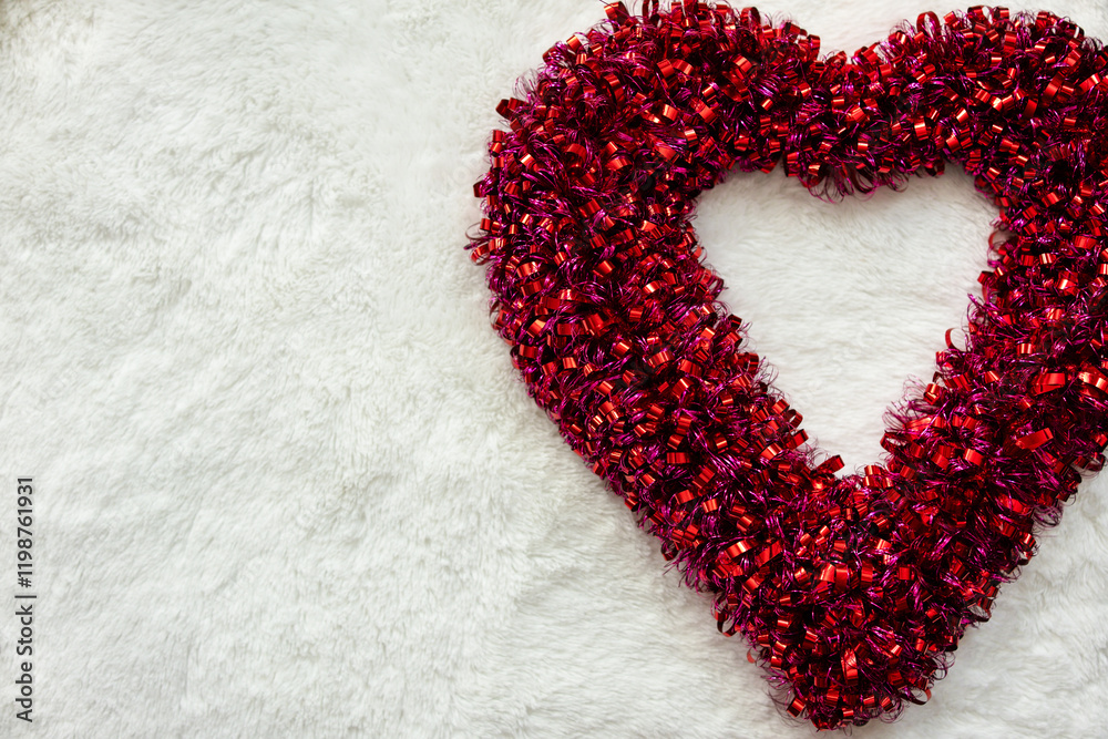 pink and red ribbon heart against a soft white background