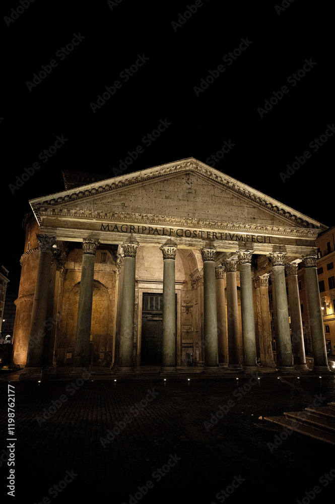 Night view of the Pantheon illuminated against a dark sky