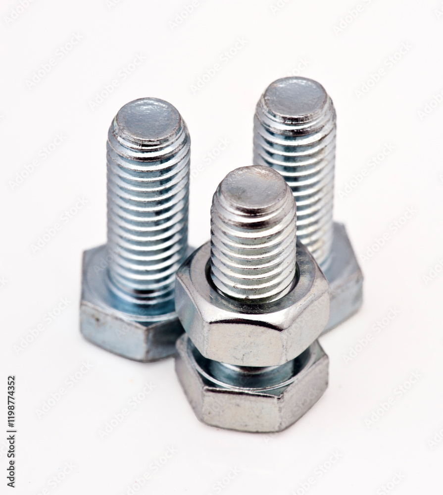 Three metallic bolts and nuts arranged in a triangular formation on a white background Three metallic bolts and nuts arranged in a triangular formation on a white background