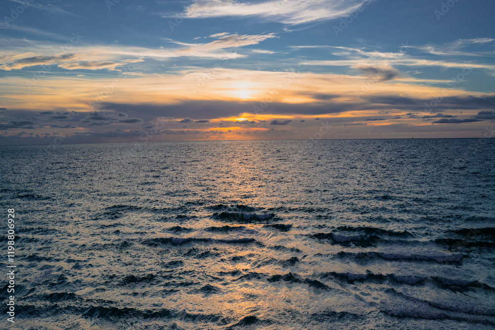 Sea sunset with cloudy sky and sun through the clouds over. Clouds Ocean and sky background, seascape. Sea sunset with cloudy sky and sun through the clouds over. Clouds Ocean and sky background, seascape.