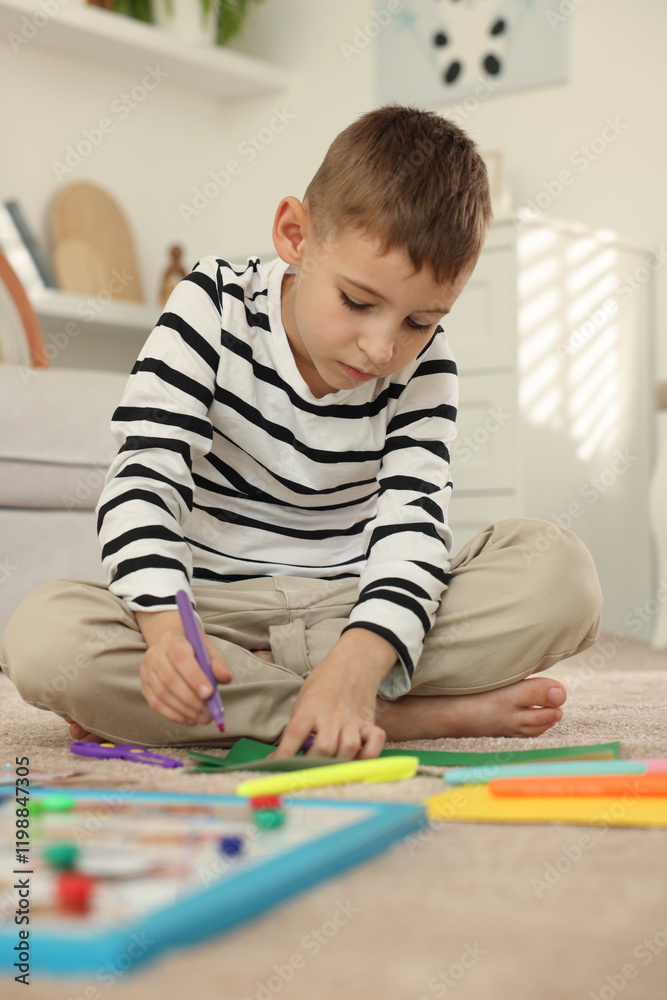 Creating vision board. Little boy drawing on card indoors Creating vision board. Little boy drawing on card indoors