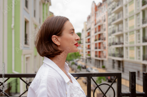 Portrait of a young woman in a white dress on the background of the city. Travelling concept photo