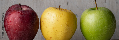 Three apples of different varieties and colors: red, yellow, green
