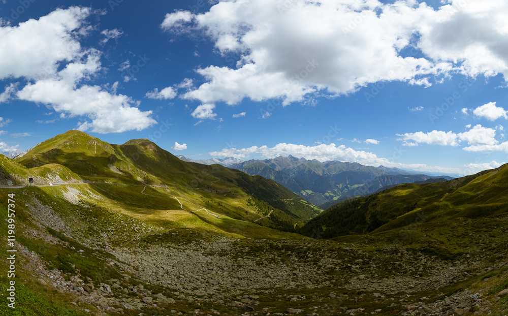 Fototapeta premium Colorful green mountain valley shot in summer under a deep blue sky