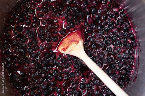 Boiling blueberries to make blueberry jam