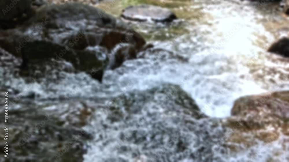 Rural river flowing through stone boulders, water clear stream river flowing in village, blurred footage of stream flowing water, bokeh video of river flowing between big rocky, blur nature background Rural river flowing through stone boulders, water clear stream river flowing in village, blurred footage of stream flowing water, bokeh video of river flowing between big rocky, blur nature background