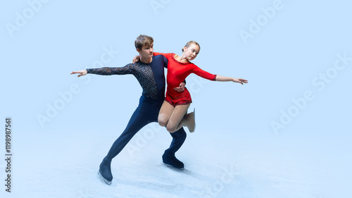Professional ice skating partners perform difficult lift, show their elegance against cold blue background. Artistic ice dance. Concept of winter sport, elegance and grace, championship. Ad