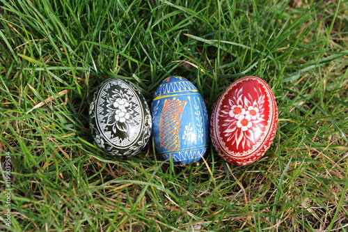 Traditional hand dyed and hand painted colorful Easter eggs on the green grass in Poland called pisanka or kroszonka or kraszonka, Poland, Europe photo