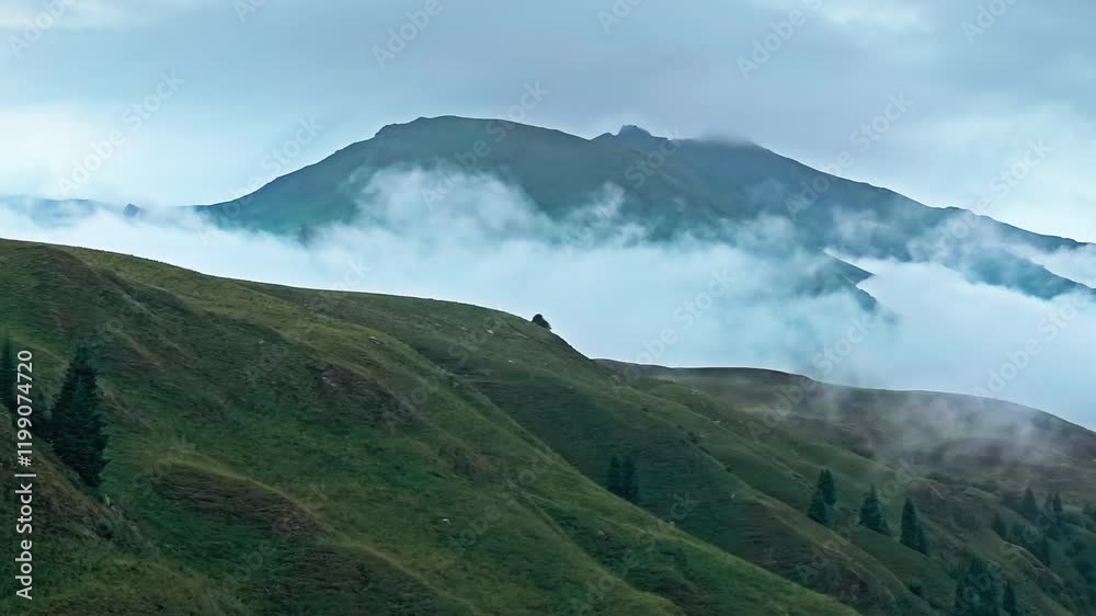 A misty mountain landscape shows green hills and cloudy sky A misty mountain landscape shows green hills and cloudy sky