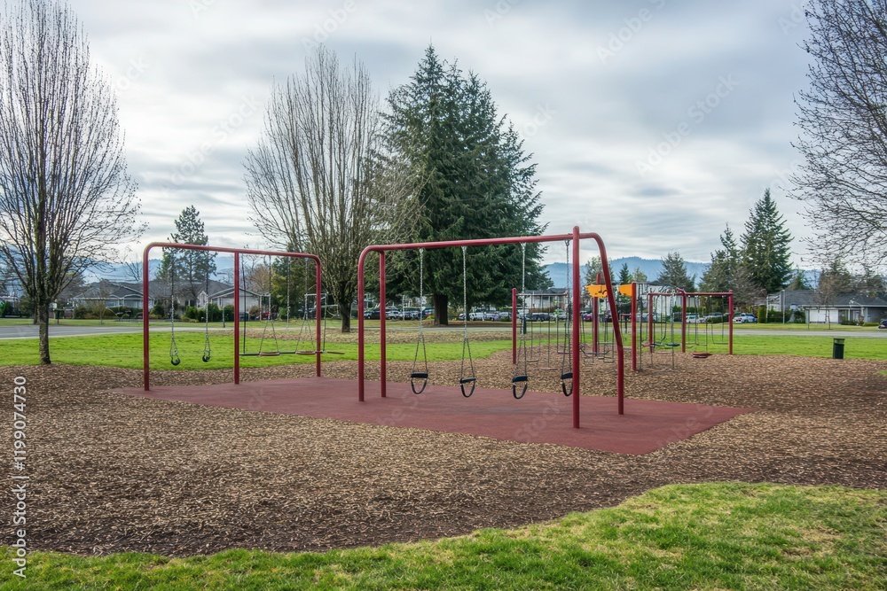 Empty Playground with Swings in a Peaceful Park Surrounded by Trees and Grass Under a Cloudy Sky in a Scenic Landscape Setting Empty Playground with Swings in a Peaceful Park Surrounded by Trees and Grass Under a Cloudy Sky in a Scenic Landscape Setting