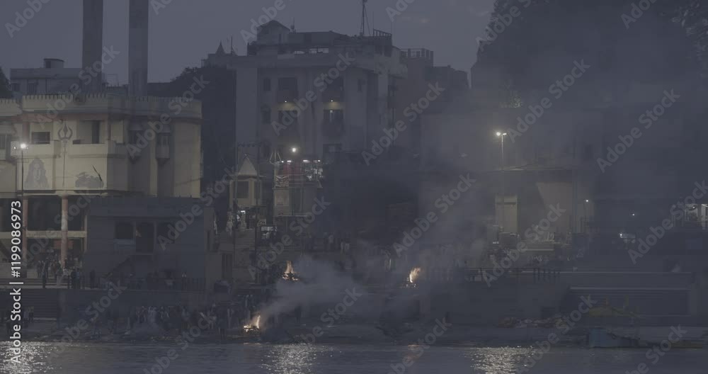 Varanasi, India. Ungraded C LOG 2 Funeral Rites Of Cremation At Harishchandra Ghat. Harishchandra Ghat Is One Of Only Two Ghats Serving As Cremation Sites Along Ganges River. View From River. Evening
