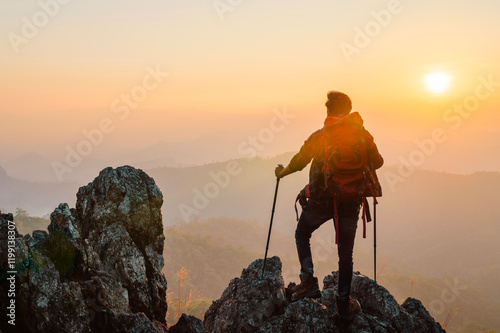 man is standing on a mountain top with a backpack and a pair of poles