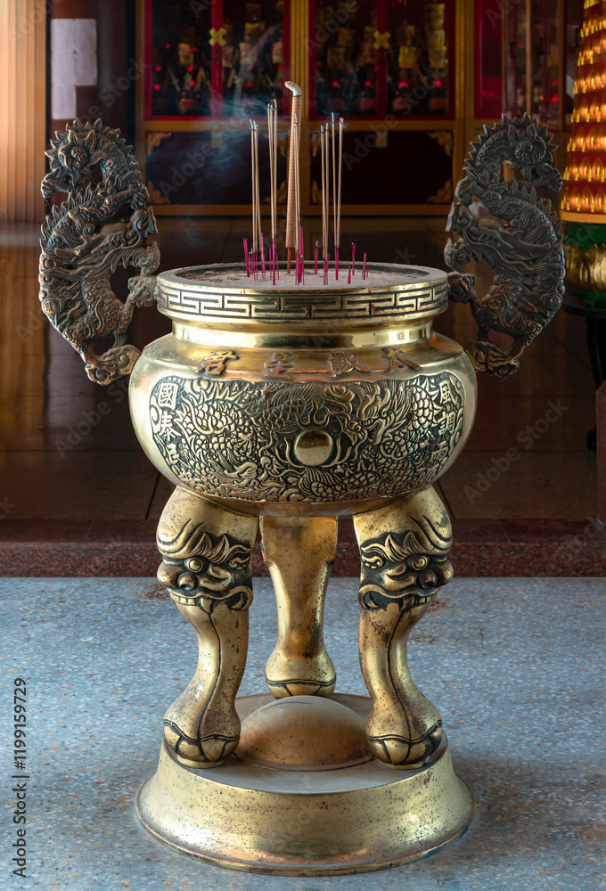 Metal dragons sculpture decorate on Golden incense burner (Incense smoke burning straight up) inside the Buddhist temple of Wat Dhammakatanyu (Xian Lo Dai Tien Gong). Taiwanese art style, Copy space.