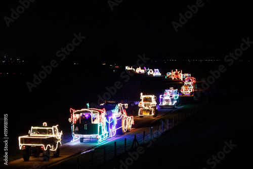 Vászonkép Celebration of illuminated agricultural vehicles parading through the polder at