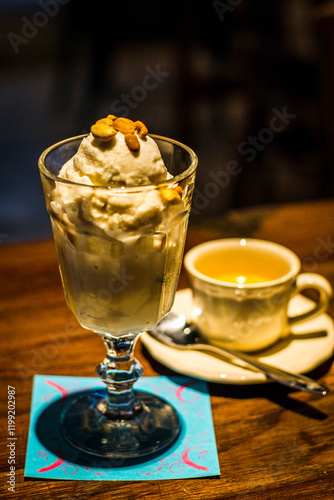 ice cream served with toasted peanuts on top and in  tall glass