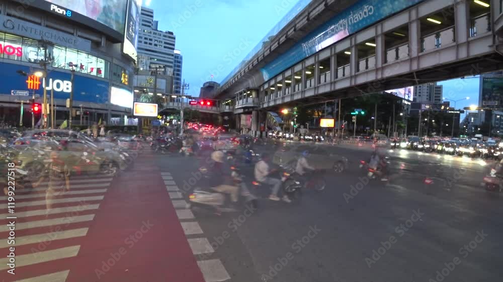 BANGKOK, THAILAND - AUGUST 2024 : View of street traffic at busy crossing. Many cars, motorbikes, tuk tuk taxi on the road. Transportation concept video. Time lapse shot in daytime.