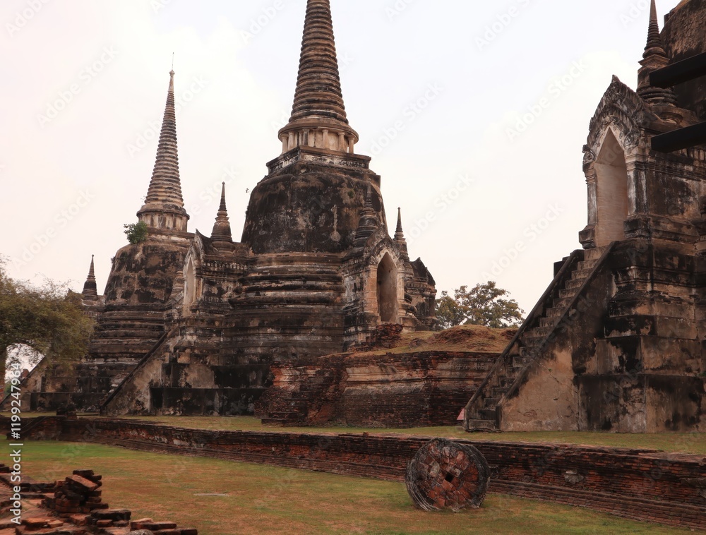 Fototapeta premium Buddha,fine arts,thailand Ancient temple ruins with tall spires and historical architecture.