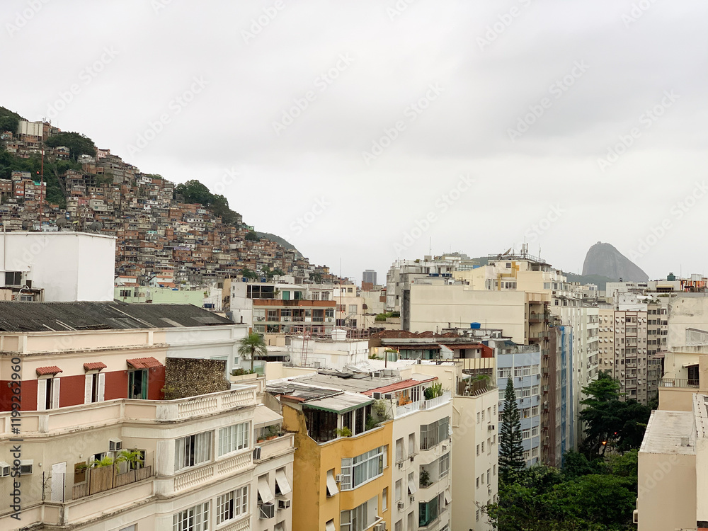 Obraz premium Urban landscape with hillside houses, dense favelas, and modern buildings in Rio de Janeiro.