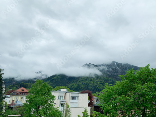 Misty mountain view in Bad Reichenhall with clouds partially covering the peaks. photo