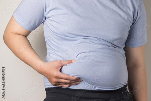 overweight or obese man shows fat deposits in the abdomen. healthcare, medicine concept. he is dieting and losing weight.