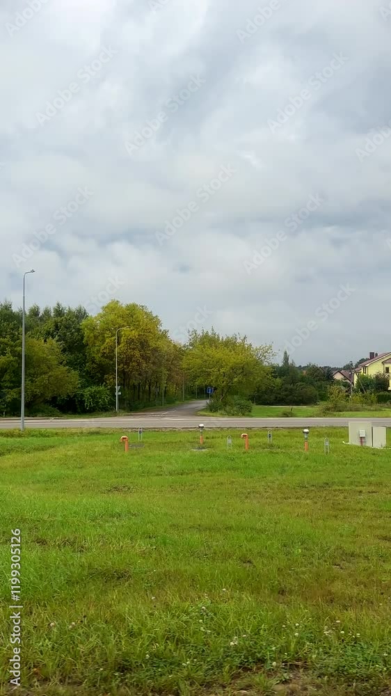 Vertical shot. Side window view traveling in Klaipeda district, Lithuania. Cars driving past residential houses of Klaipeda county.
Vertical shot. Side window view traveling in Klaipeda district, Lithuania. Cars driving past residential houses of Klaipeda county.