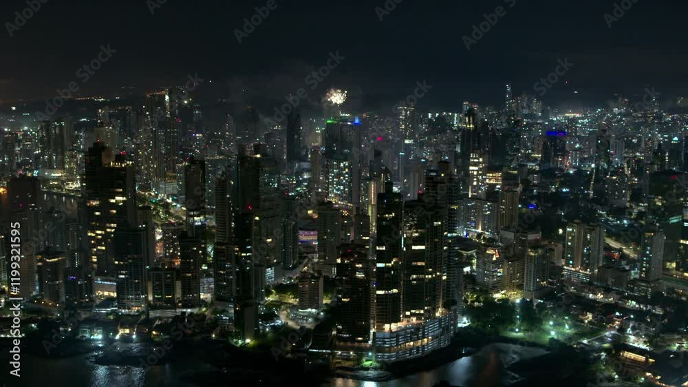 Tilt up drone shot on a city with skyscrapers celebrating new years with fireworks on the sky Tilt up drone shot on a city with skyscrapers celebrating new years with fireworks on the sky