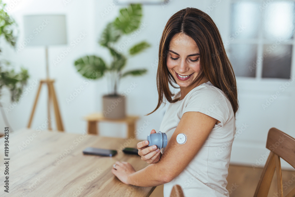 Smiling Woman Using Glucose Monitor At Home For Health Management Smiling Woman Using Glucose Monitor At Home For Health Management